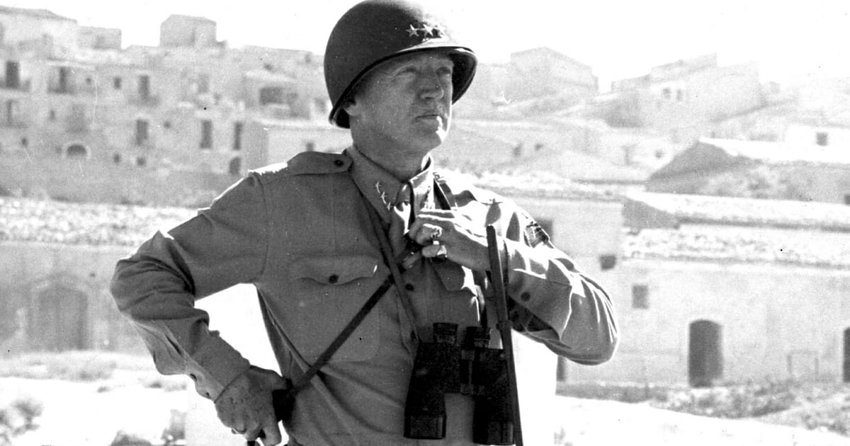Portrait of American military commander Lieutenant General George S. Patton (1885 - 1945) as he stands on a beach during the campaign to liberate Sicily, Italy, in 1943.