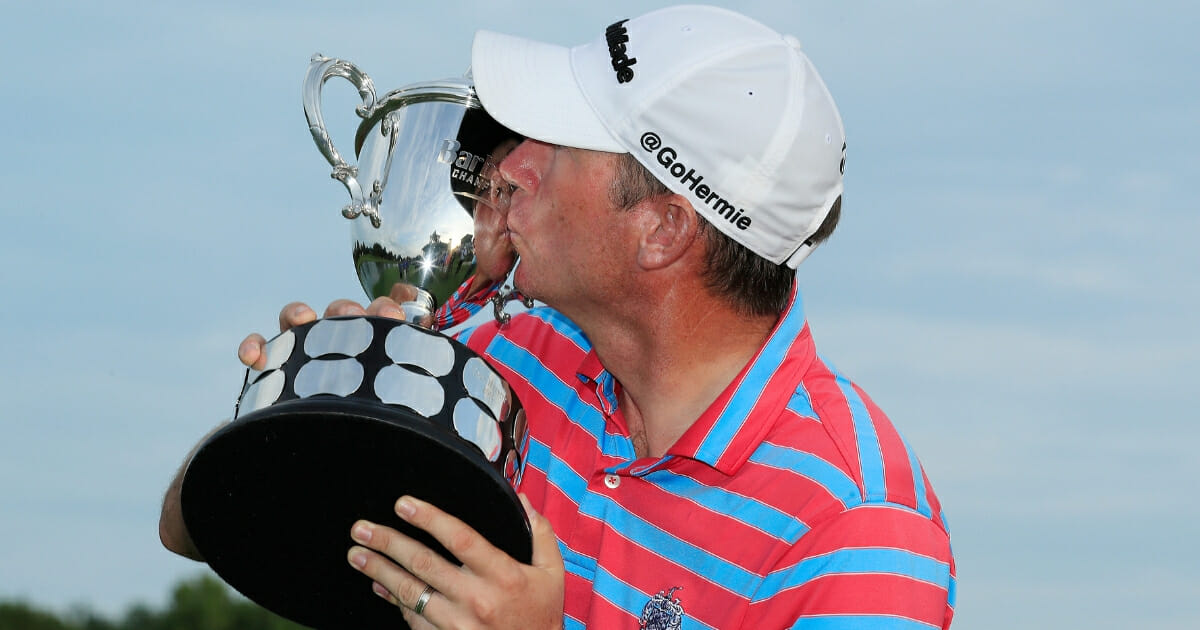 PGA Tour player Jim Herman kisses trophy