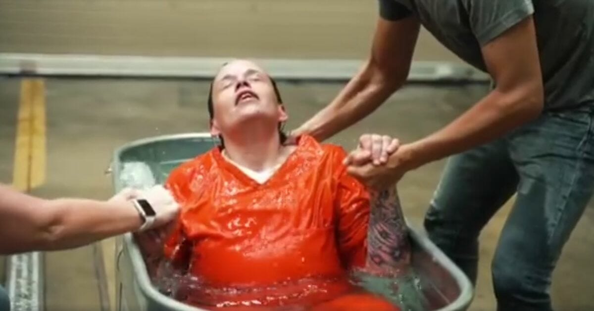 A prisoner is baptized.