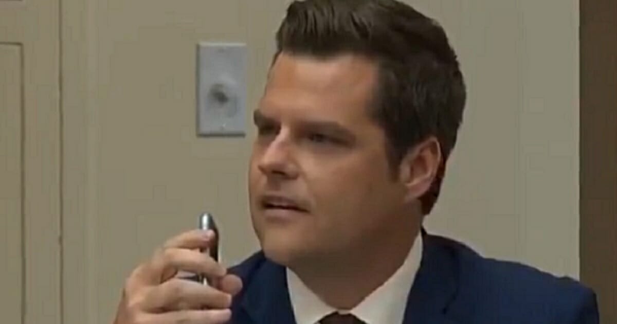Florida Republican Rep. Matt Gaetz holds a cell phone during a House Judiciary Committee hearing.