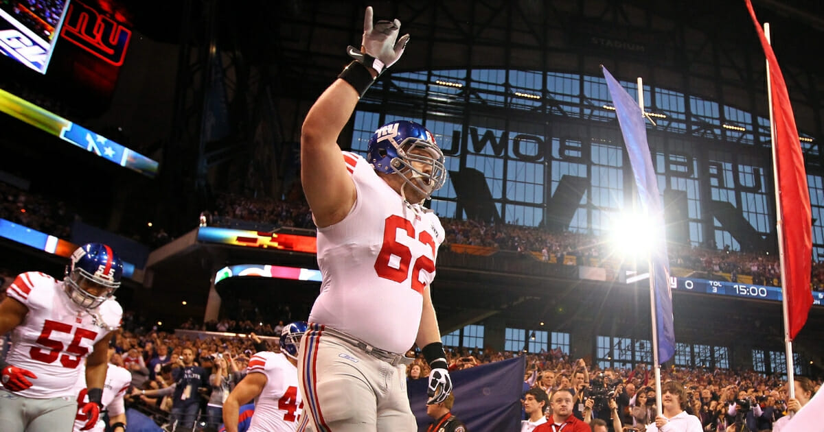 Mitch Petrus of the New York Giants takes the field for Super Bowl XLVI against the New England Patriots.