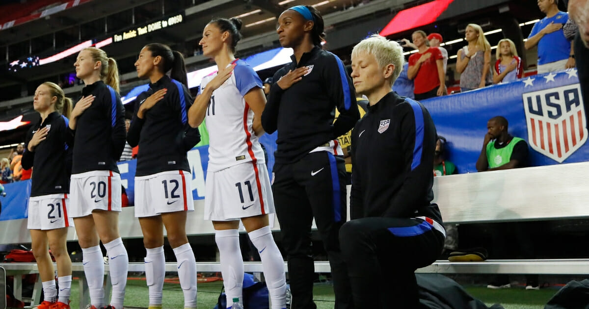 Megan Rapinoe #15 kneels during the National Anthem prior to the match between the United States and the Netherlands at Georgia Dome on Sept. 18, 2016 in Atlanta, Georgia.