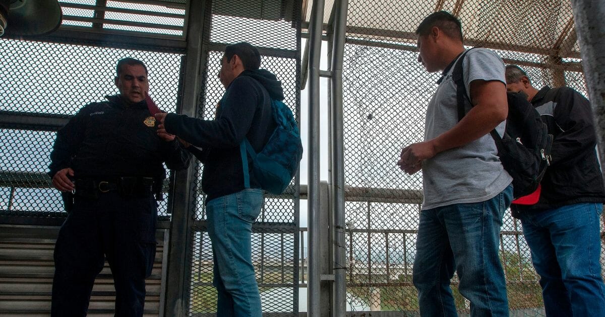 Men wait to cross from the Mexican city of Reynosa, Tamaulipas State, into the U.S. city of Hidalgo, in Texas, over the Reynosa-Hidalgo International bridge on Jan. 9, 2019.