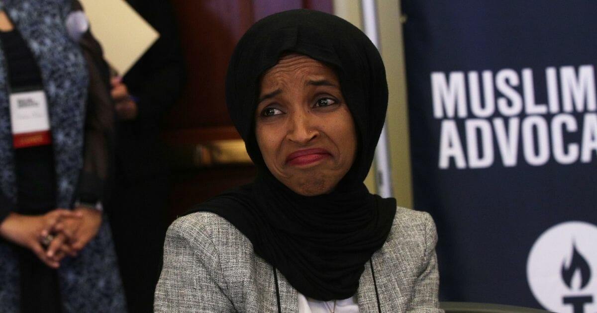 Rep. Ilhan Omar reacts as she listens to remarks during a congressional Iftar event on May 20, 2019, in Washington, D.C.