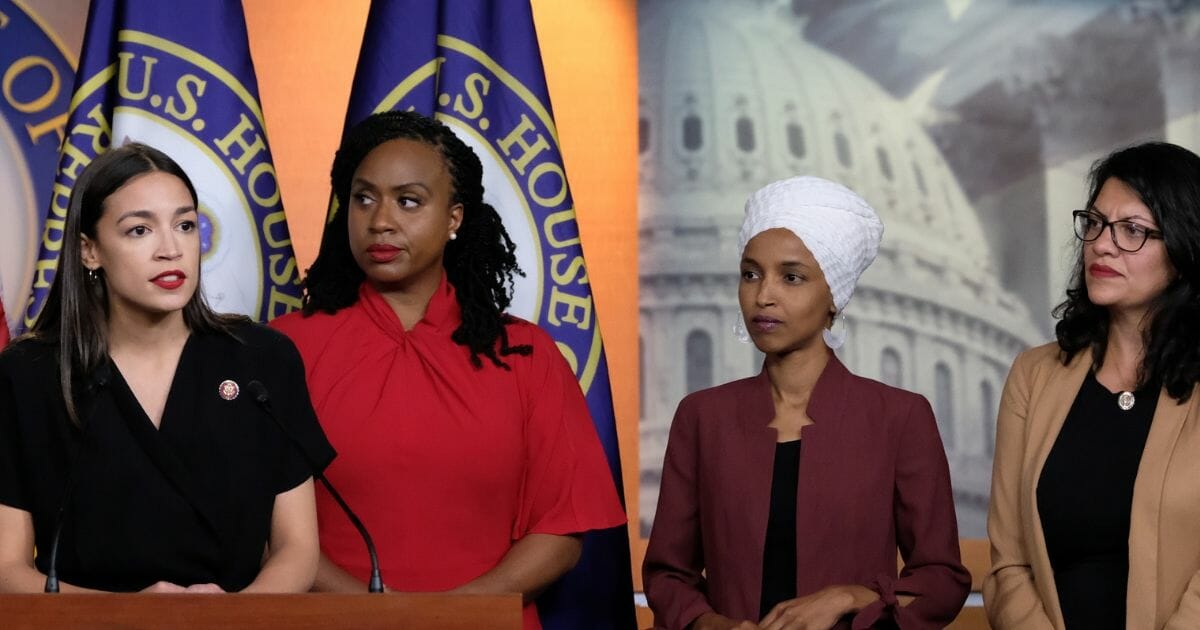 U.S. Rep. Alexandria Ocasio-Cortez (D-NY) speaks as Reps. Ayanna Pressley (D-MA), Ilhan Omar (D-MN), and Rashida Tlaib (D-MI) listen during a press conference at the US Capitol on July 15, 2019, in Washington, D.C.