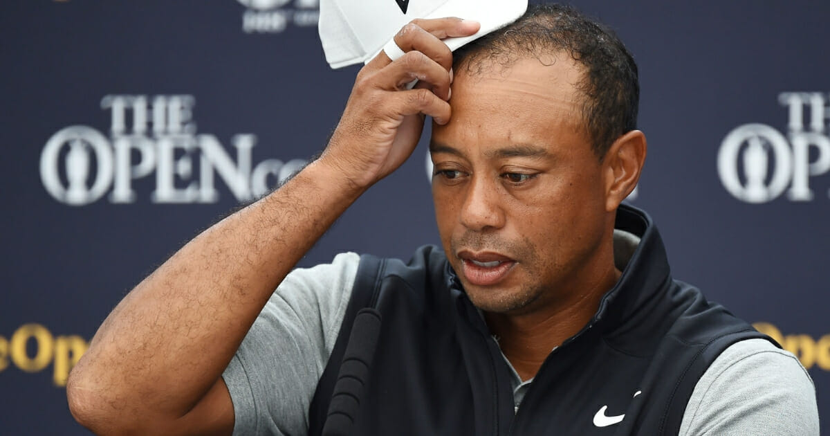 Tiger Woods scratches his head during a news conference in advance of the British Open.