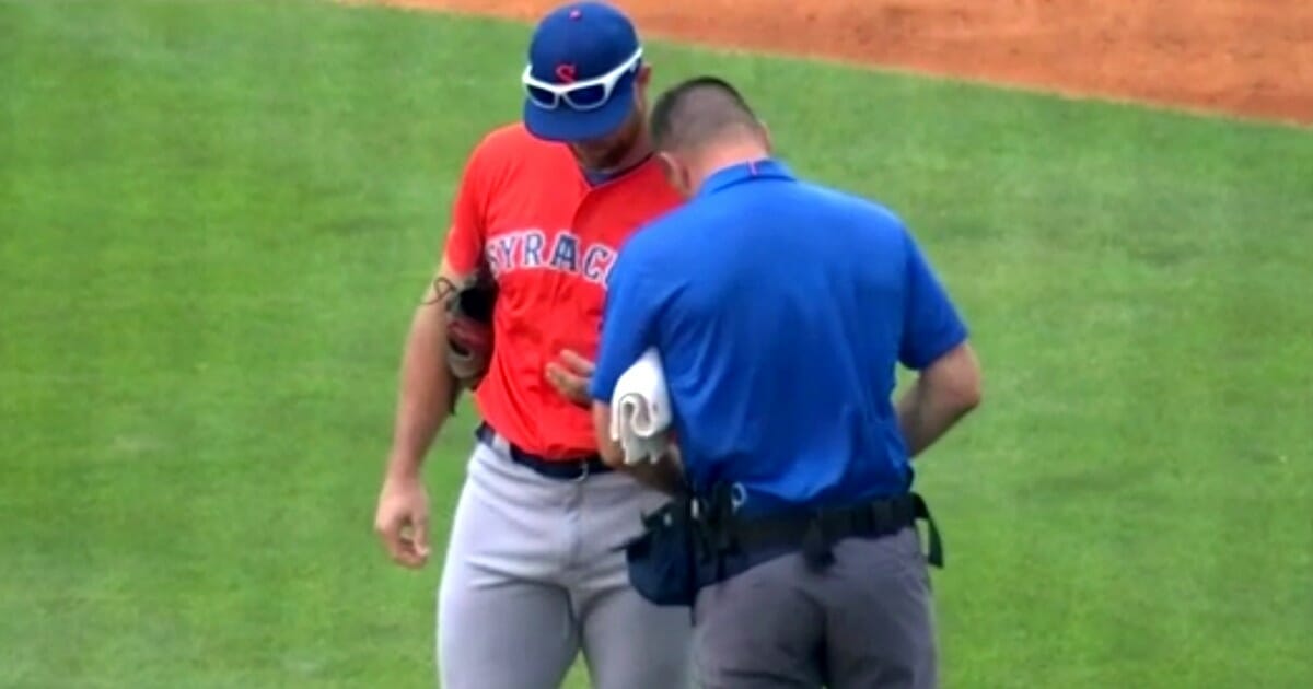 Syracuse Mets outfielder is checked out after injuring his hand.