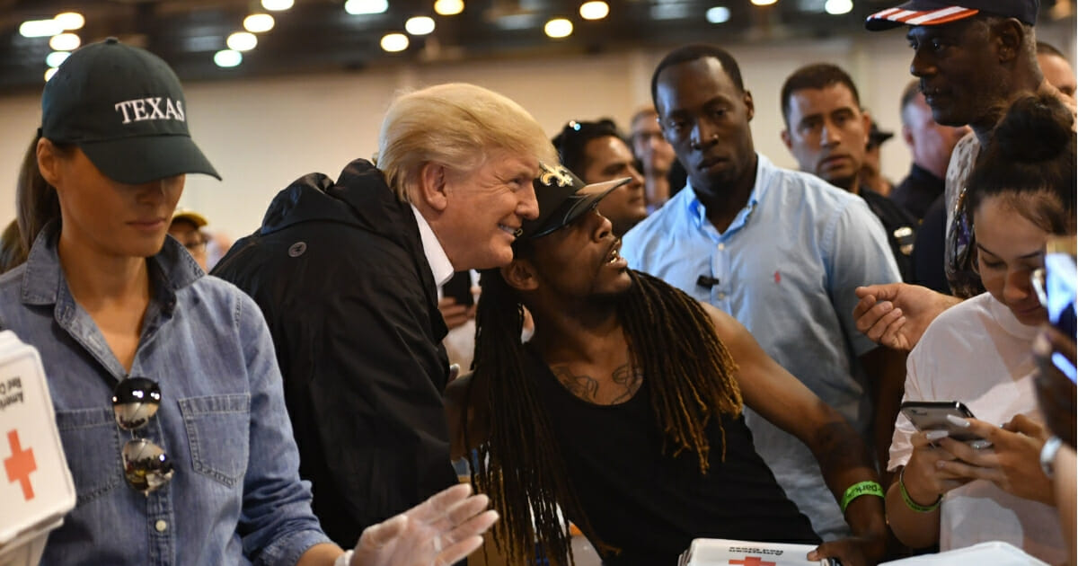 President Donald Trump and first lady Melania Trump serve food to victims of Hurricane Harvey at NRG Center in Houston.