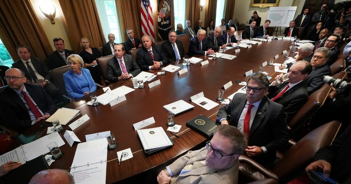 President Donald Trump (center) listens to a presentation during a cabinet meeting at the White House July 16, 2019, in Washington, D.C.