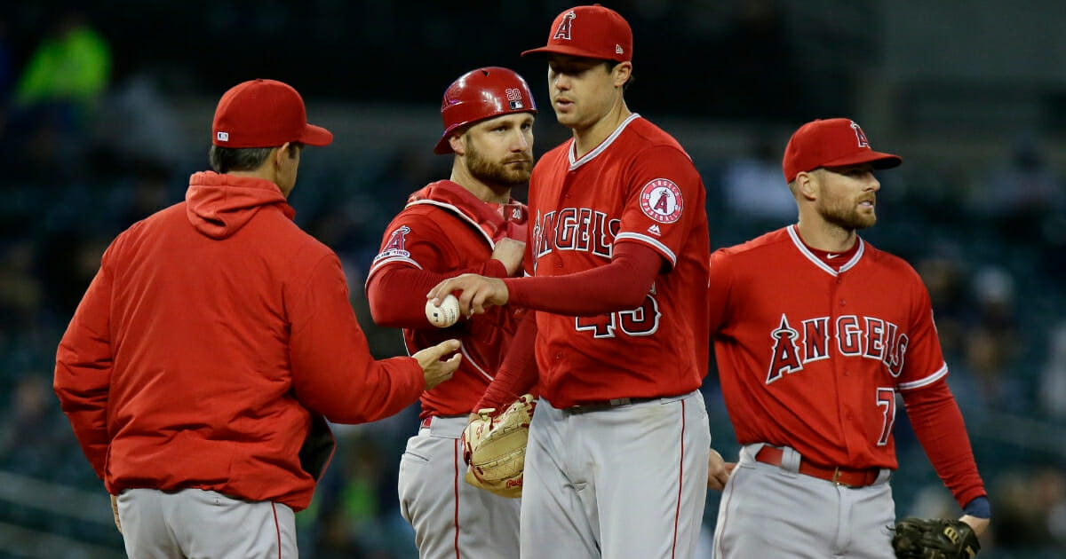 Los Angeles Angels pitcher Tyler Skaggs gives up the ball to manager Brad Ausmus.
