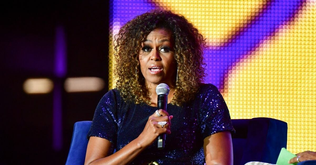 Former first lady Michelle Obama sports a "natural" hairstyle Saturday at the Essence Festival in New Orleans. The look might have been new for Obama, but her message hasn't changed.