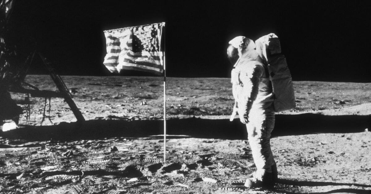 Astronaut Buzz Aldrin stands with the American flag on the moon, July 20, 1969.