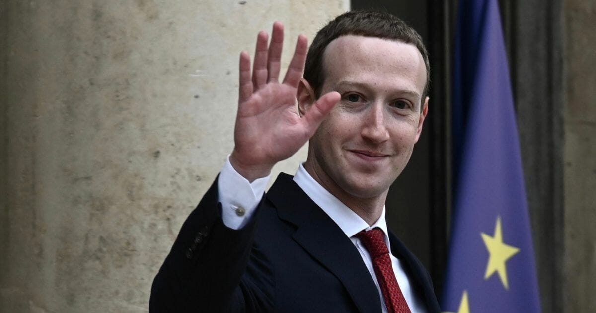 Facebook CEO Mark Zuckerberg waves to the camera.