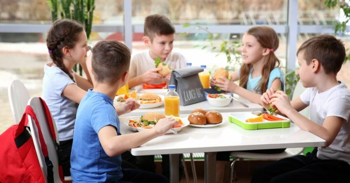 Children eating lunch at a cafeteria table