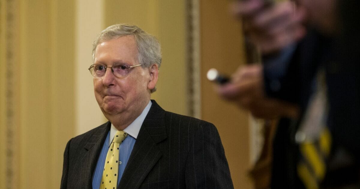 Senate Majority Leader Mitch McConnell walks to the podium before speaking during a news conference