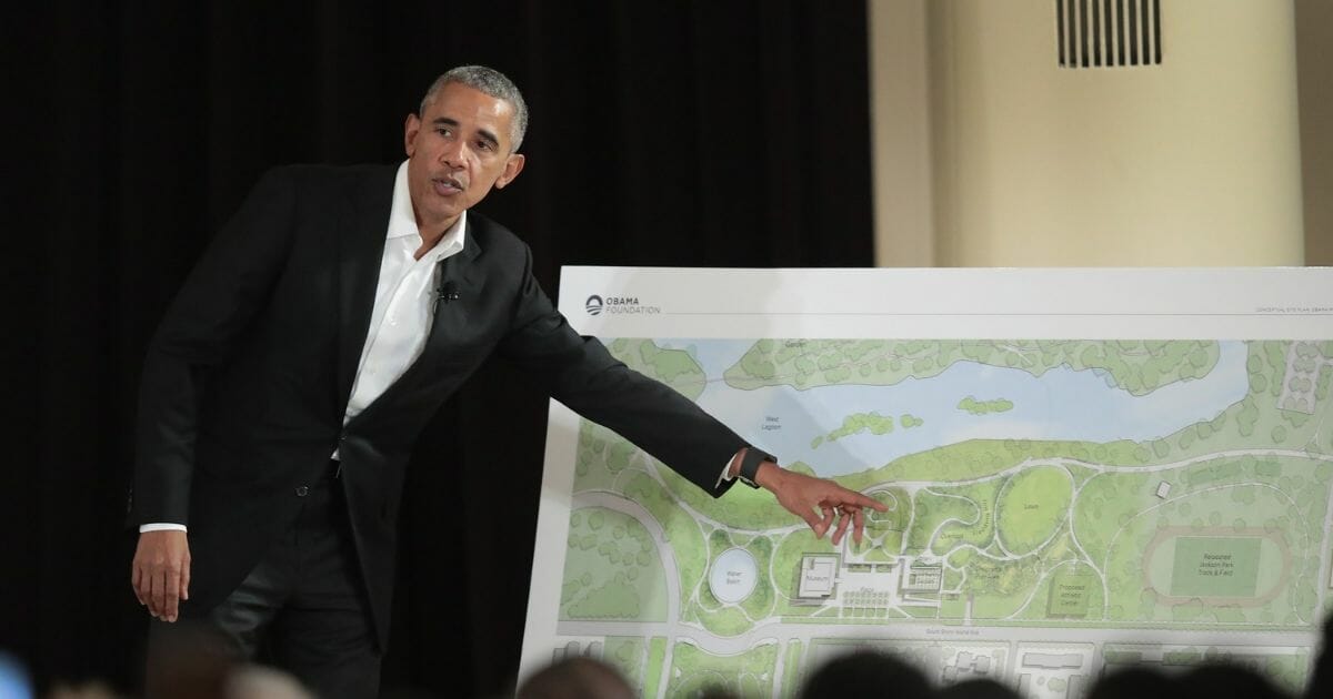 Former President Barack Obama gestures at a plan for the Obama Presidential Center in Chicago during a public meeting in 2017.