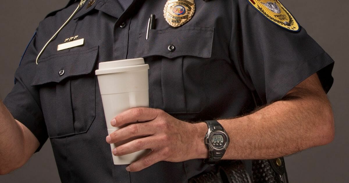 Police officer with coffee cup