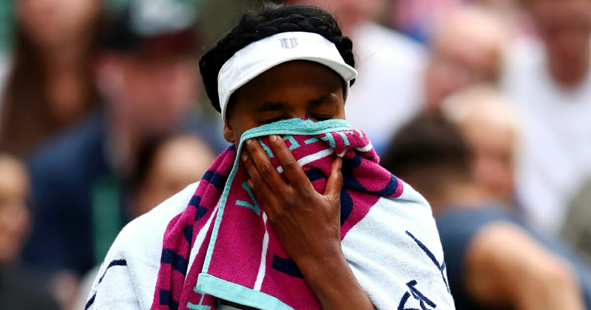 Venus Williams puts a towel over her face between games in her first-round match against 15-year-old Cori Gauff at Wimbledon.