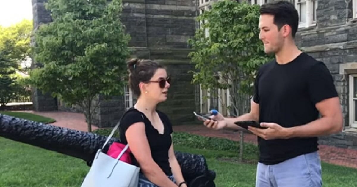 Cabot Phillips of Campus Reform interviews a young woman on a college campus.