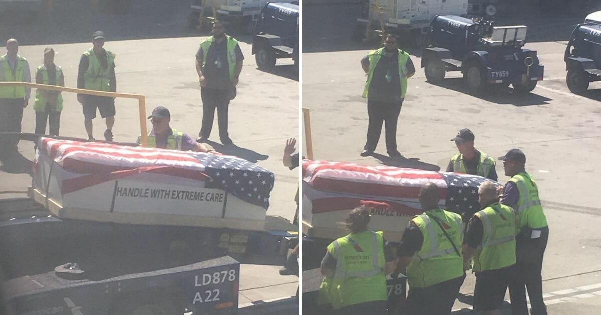 Ground crew loading a casket draped with a flag onto a plane