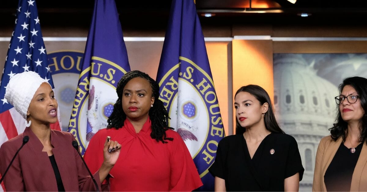 Reps. Ilhan Omar (D-MN) speaks as, Ayanna Pressley (D-MA), Alexandria Ocasio-Cortez (D-NY), and Rashida Tlaib (D-MI) listen during a media conference at the U.S. Capitol on July 15, 2019, in Washington, D.C.