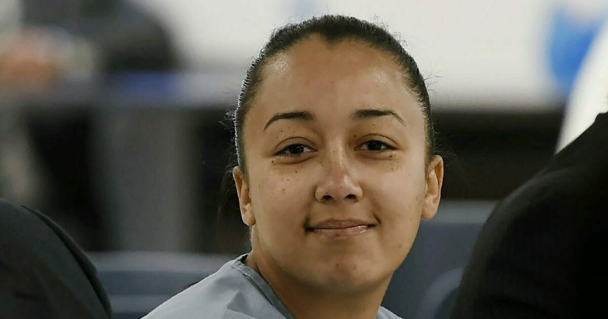 In this May 23, 2018, file pool photo, Cyntoia Brown, a woman serving a life sentence for killing a man when she was a 16-year-old prostitute, smiles at family members during her clemency hearing at Tennessee Prison for Women in Nashville, Tenn. Brown who said she was a teenage sex-trafficking victim when she killed a man in 2004 is scheduled to be released from prison on Wednesday, Aug. 7, 2019, after being granted clemency.