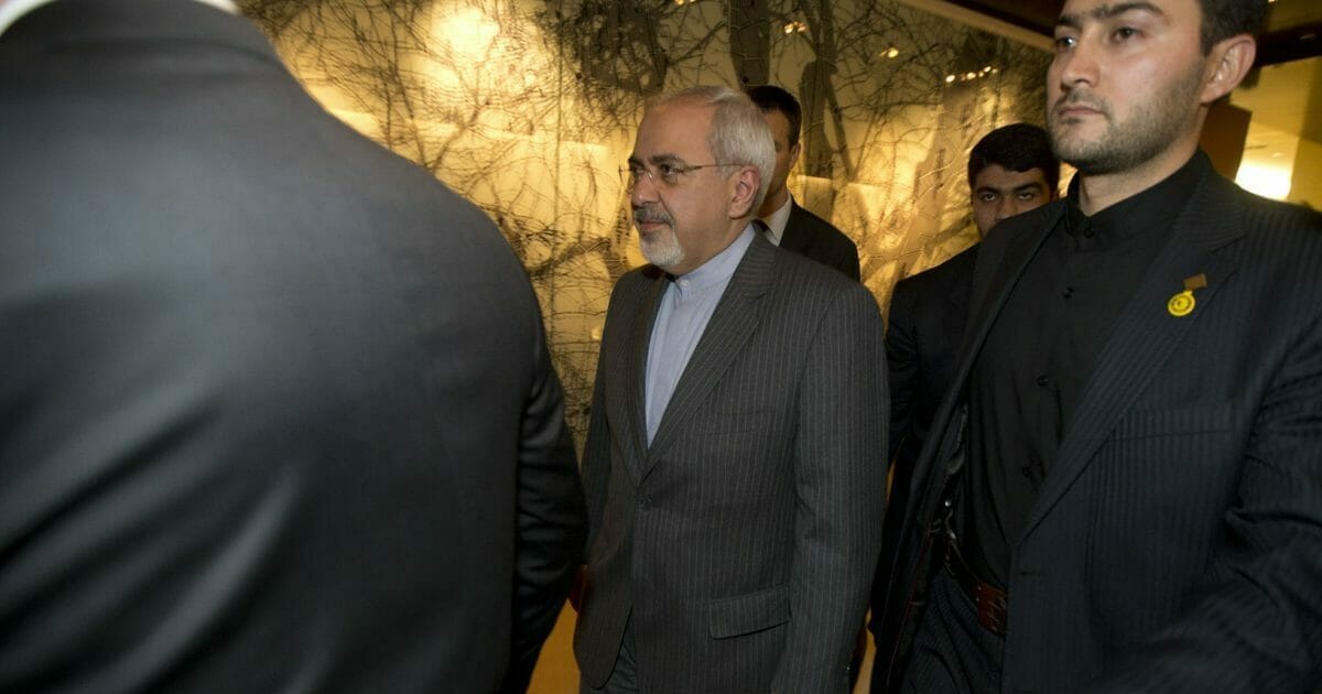 In this Nov. 9, 2013, file photo, Iranian Foreign Minister Mohammad Javad Zarif, center, leaves following a meeting with EU foreign ministers at the Iran Nuclear talks in Geneva, Switzerland.
