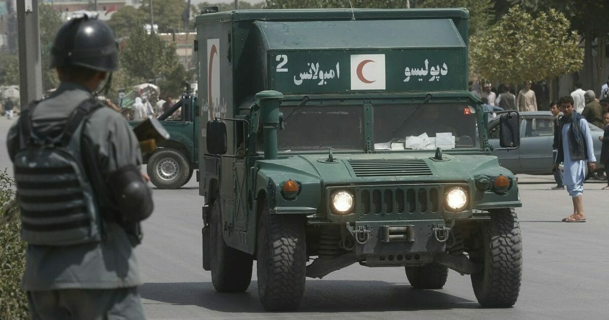 An Afghan military ambulance rushes towards the site of an explosion near police headquarters in Kabul, Afghanistan, Wednesday, Aug. 7, 2019.