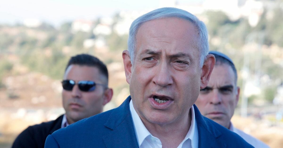 Israel's Prime Minister Benjamin Netanyahu speaks to the press at the site where an off-duty Israeli soldier was found dead with stab wounds near the settlement of Migdal Oz in the occupied West Bank on Aug. 8, 2019.