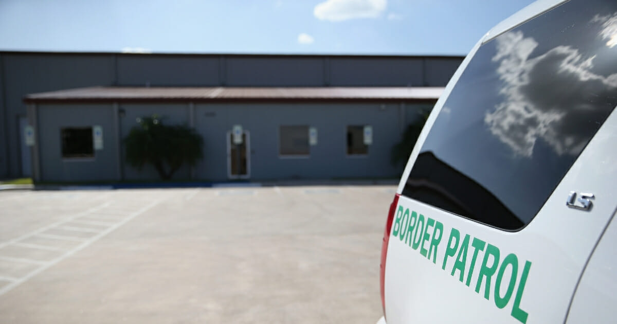 A U.S. Border Patrol vehicle sits parked outside a detention facility in McAllen, Texas.