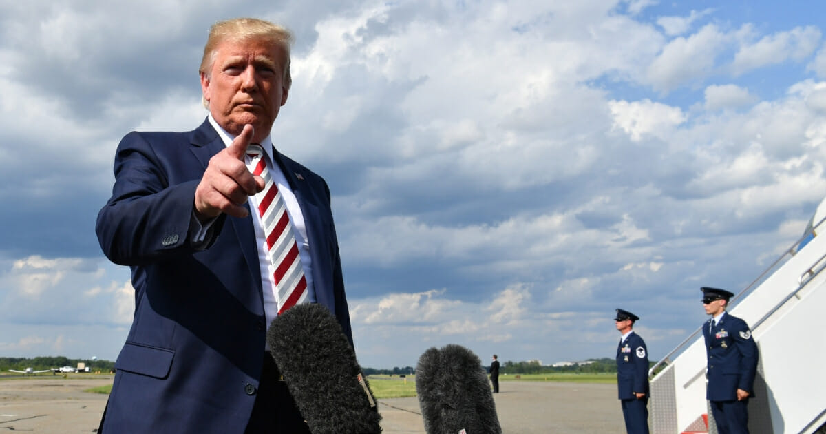 President Donald Trump gives a statement about the recent mass shootings in El Paso and Dayton before boarding to Washington at Morristown Airport on Aug. 4, 2019.