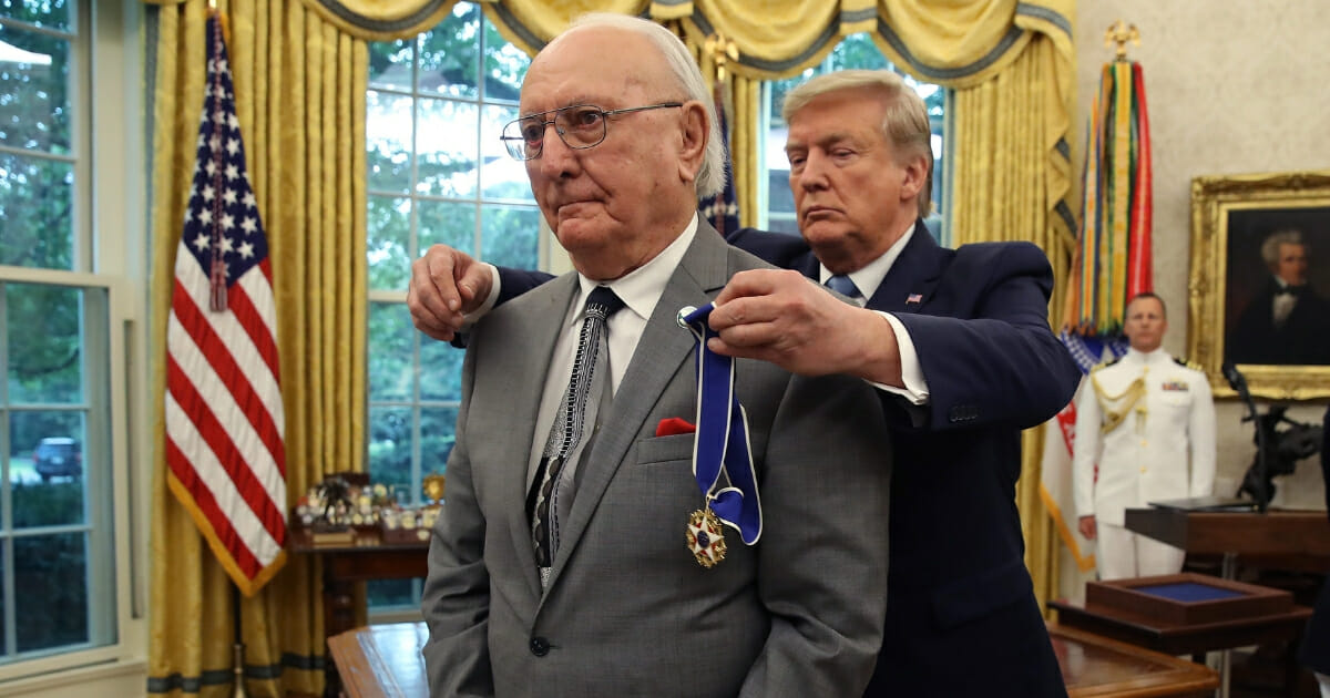President Donald Trump presents the Medal of Freedom to retired Boston Celtic Bob Cousy in the Oval Office at the White House on Aug. 22, 2019.