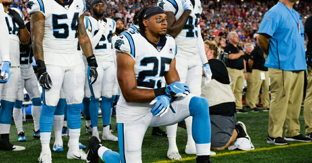 Eric Reid #25 of the Carolina Panthers kneels during the playing of the national anthem prior to the start of the preseason game against the New England Patriots at Gillette Stadium on Aug. 22, 2019, in Foxborough, Massachusetts.