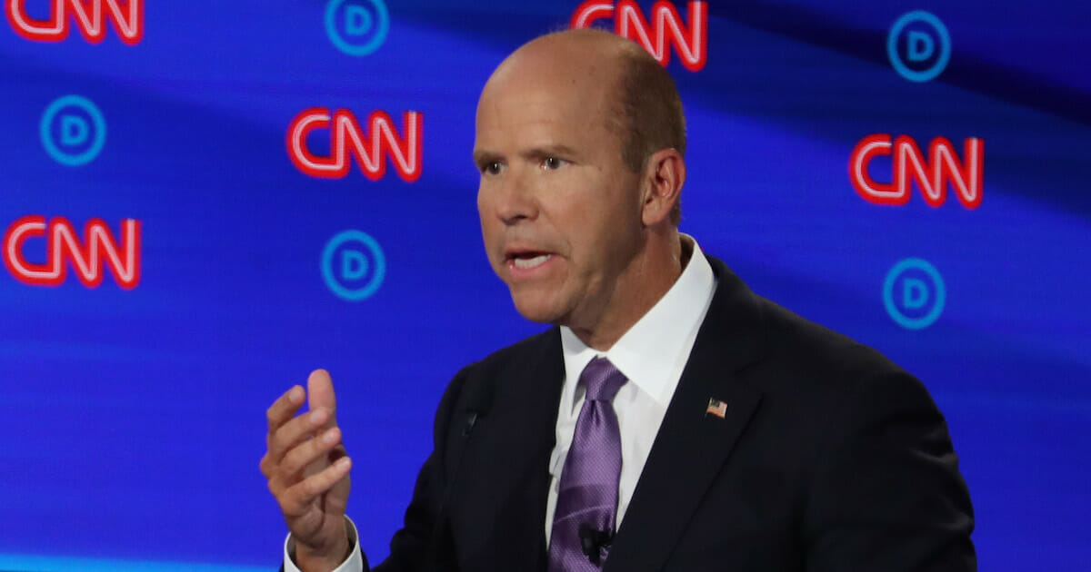 Democratic presidential candidate former Maryland congressman John Delaney speaks while former Colorado governor John Hickenlooper listens during the Democratic Presidential Debate at the Fox Theatre July 30, 2019, in Detroit, Michigan. Twenty Democratic presidential candidates were split into two groups of 10 to take part in the debate sponsored by CNN.