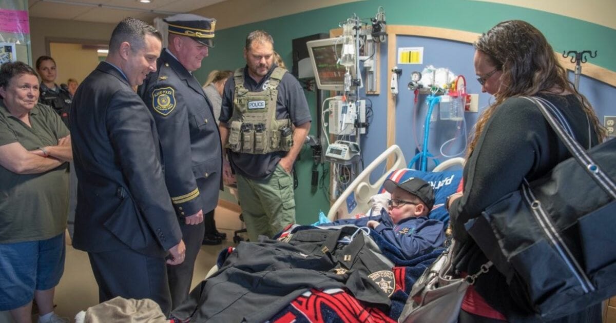 Officers show support for boy with brain cancer.