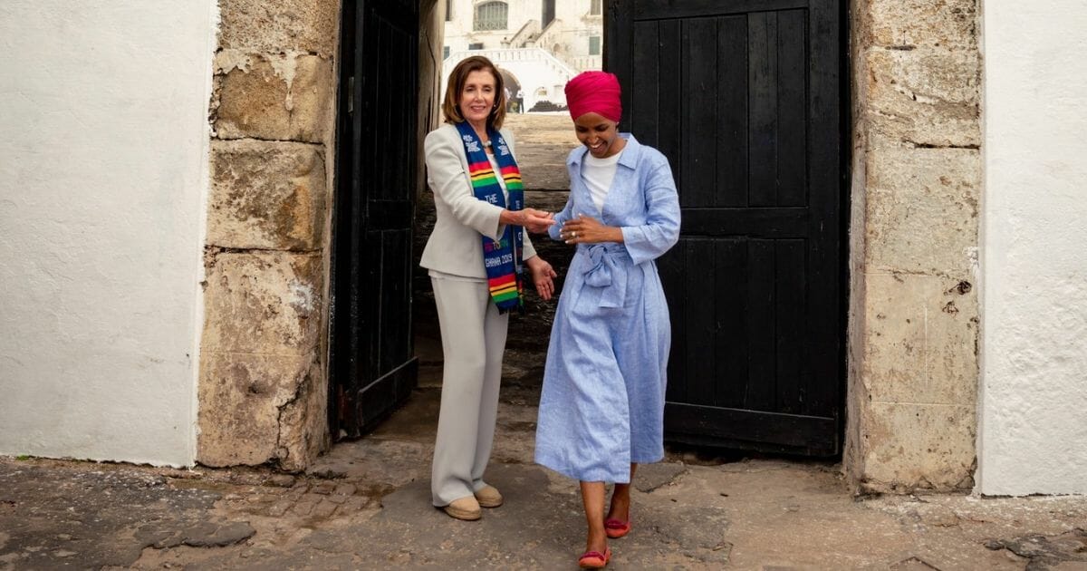 Speaker of the House Nancy Pelosi, left, and Rep. Ilhan Omar visiting the Door of No Return memorial in Ghana, Africa.