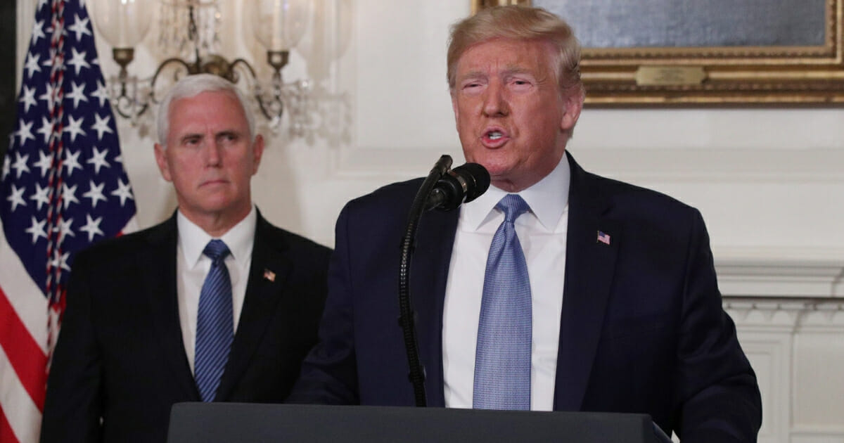 President Donald Trump speaks about the weekend's mass shootings as Vice President Mike Pence looks on.