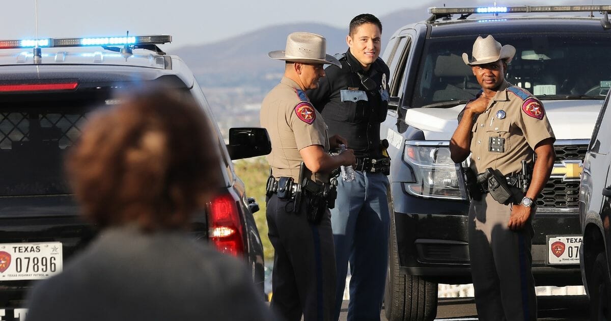 Texas law enforcement officers keep watch outside a Walmart in El Paso, Texas, on Saturday after a gunman killed at least 20 people and wounded 26 before being apprehended.