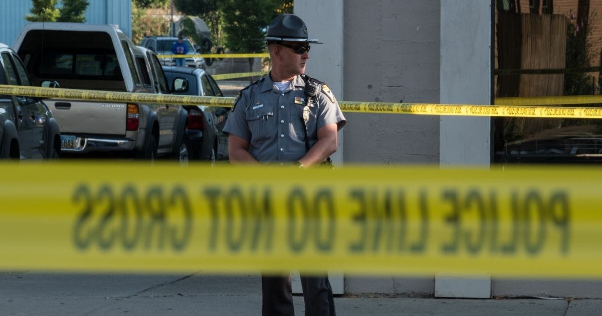 Law enforcement stands guard at the site of the Dayton, Ohio, mass shooting on Sunday morning.