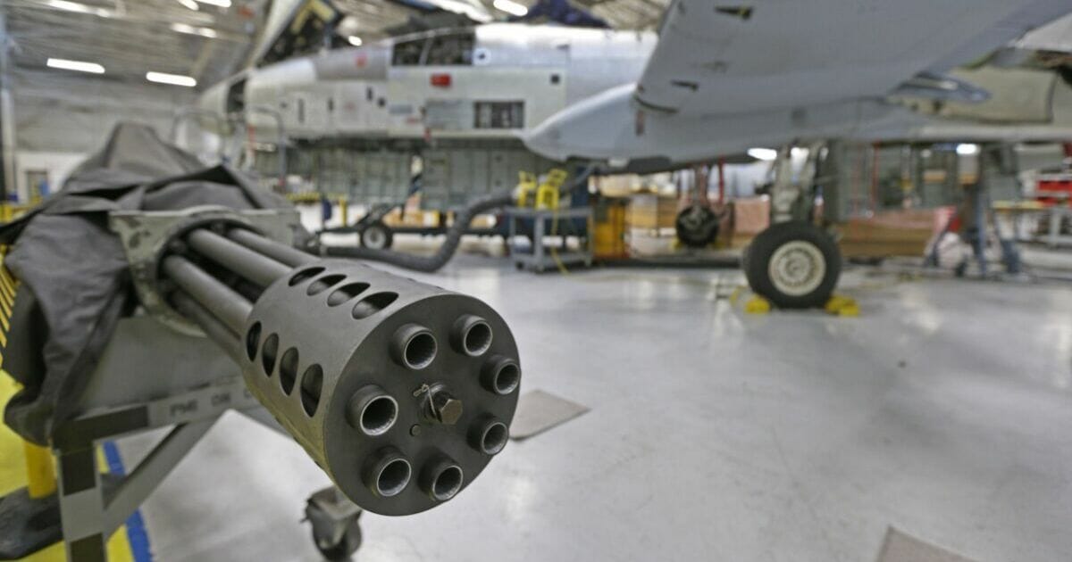 A 30mm cannon from an A-10 sits to the side as a aircraft mechanic works on an A-10 Thunderbolt Warthog at Hill Air Force base in Ogden, Utah