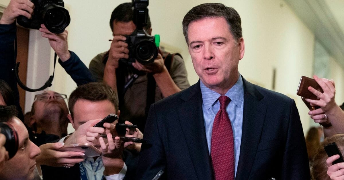 Former FBI Director James Comey is surrounded by reporters in a file photo from December 2018, when Comey testified before the House Judiciary Committee in a closed hearing. Comey was at the center of the FBI's investigation of supposed "collusion" between the Trump campaign and Russia.