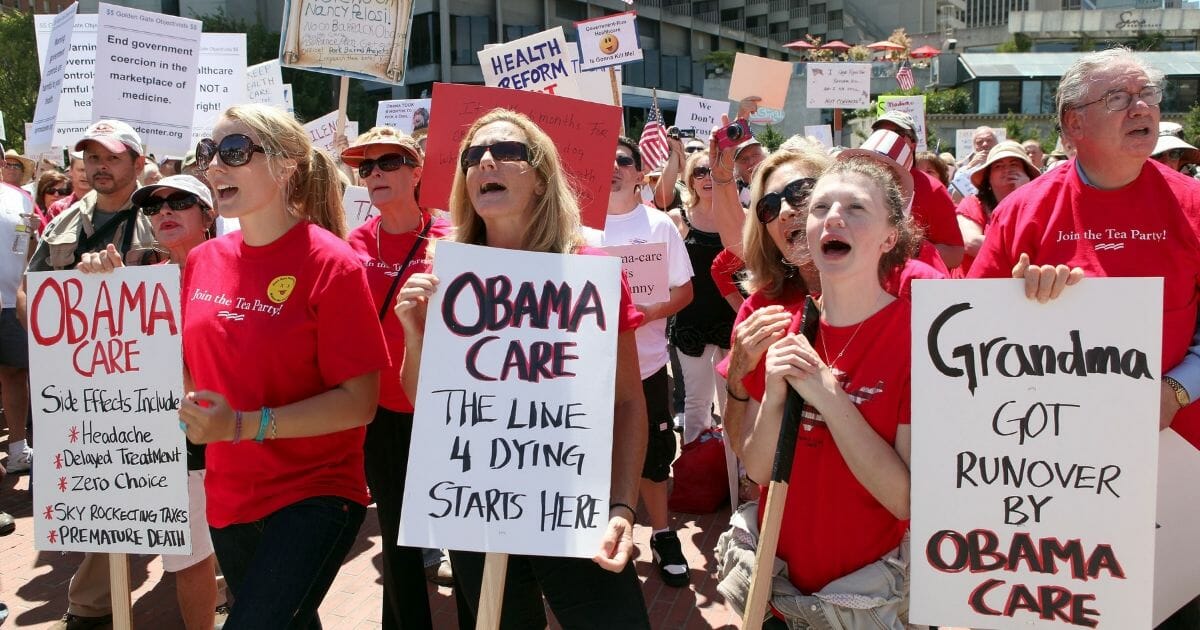 Tea party movement activists hold signs during an anti-Obamacare rally on Aug. 14, 2009, in San Francisco, California.
