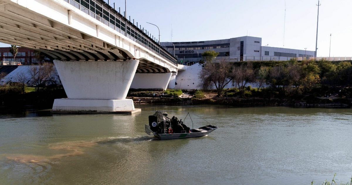 An airboat from the Laredo, Texas, South Border Patrol Station leaves to patrol the Rio Grande River near the Laredo, Texas, checkpoint, on January 13, 2019. - The International Bridge and border crossing into Nuevo Laredo, Mexico, are visible in the background.