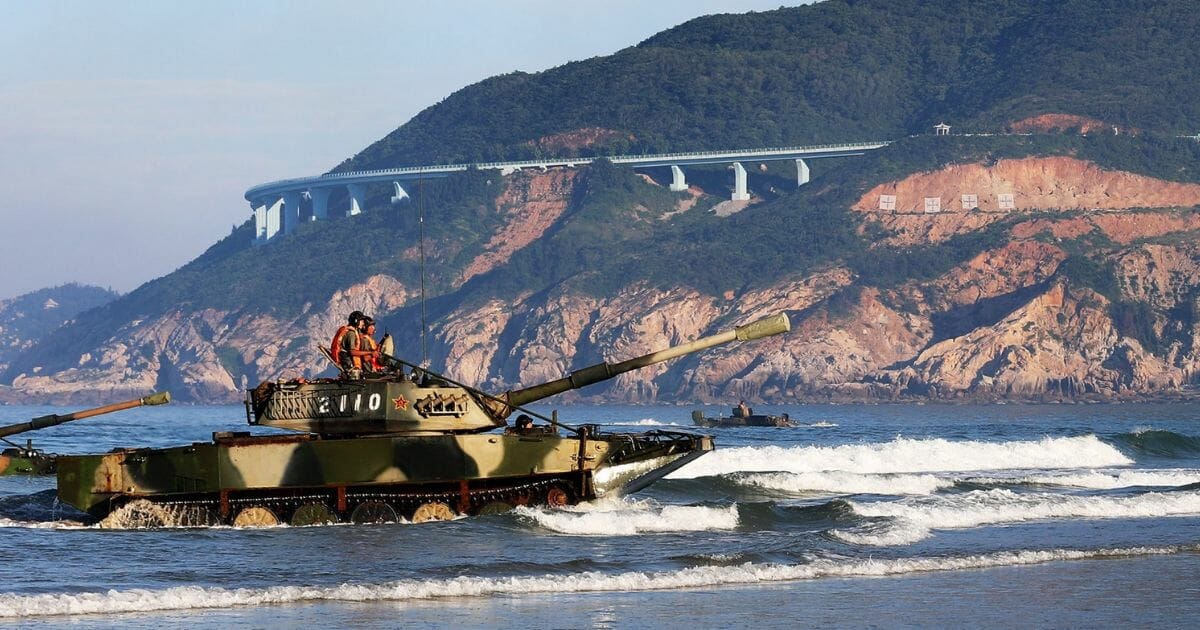 Chinese troops storm a beach as part of a military exercise.