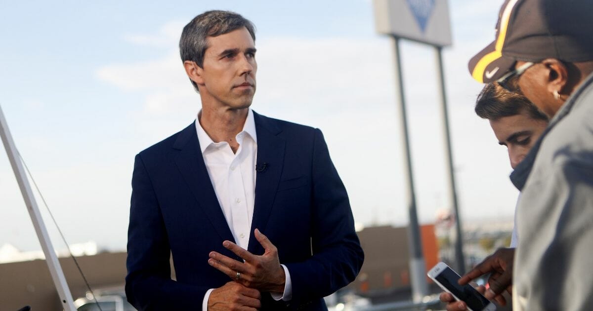 Democratic presidential candidate and former Rep. Beto O’Rourke prepares to be interviewed outside Walmart near the scene of a mass shooting.