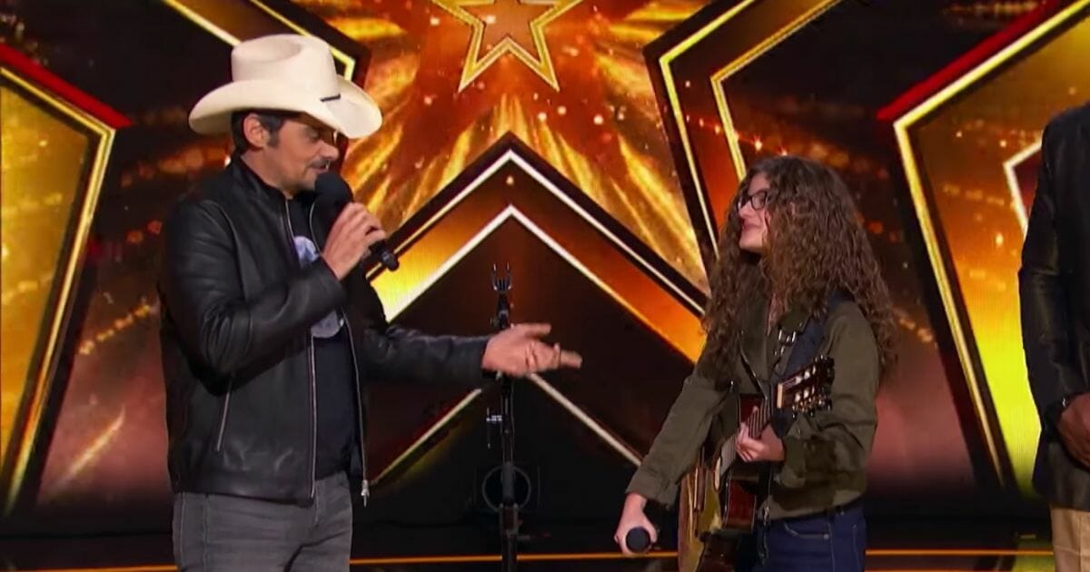 Brad Paisley on stage with 15-Year-Old Sophie Pecora.