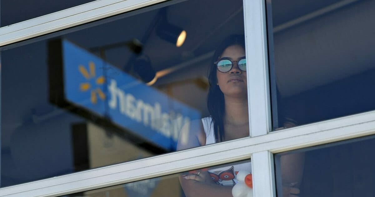 A restaurant employee looks at the scene of a mass shooting at a shopping complex Sunday, Aug. 4, 2019, in El Paso, Texas.