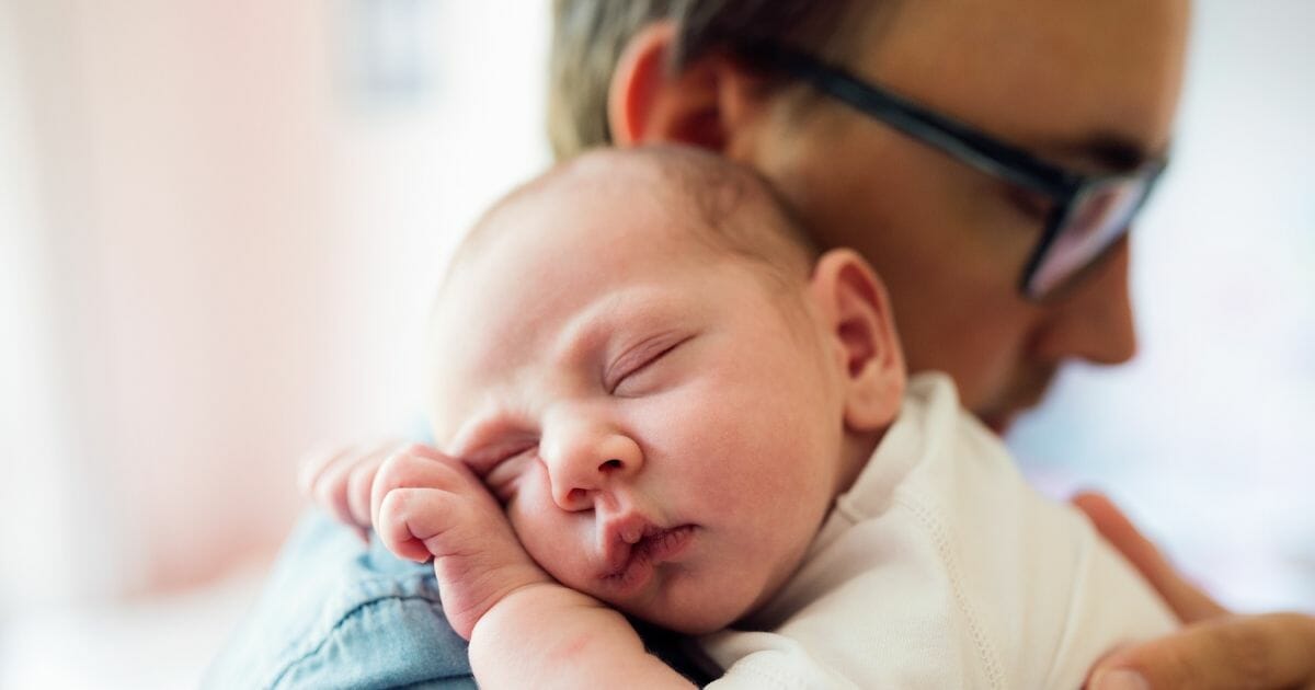 Father holding baby.