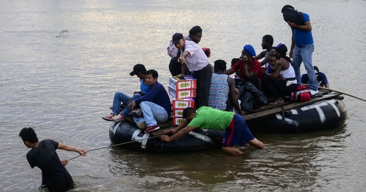 Migrants use a makeshift raft to illegally cross the Suchiate river.