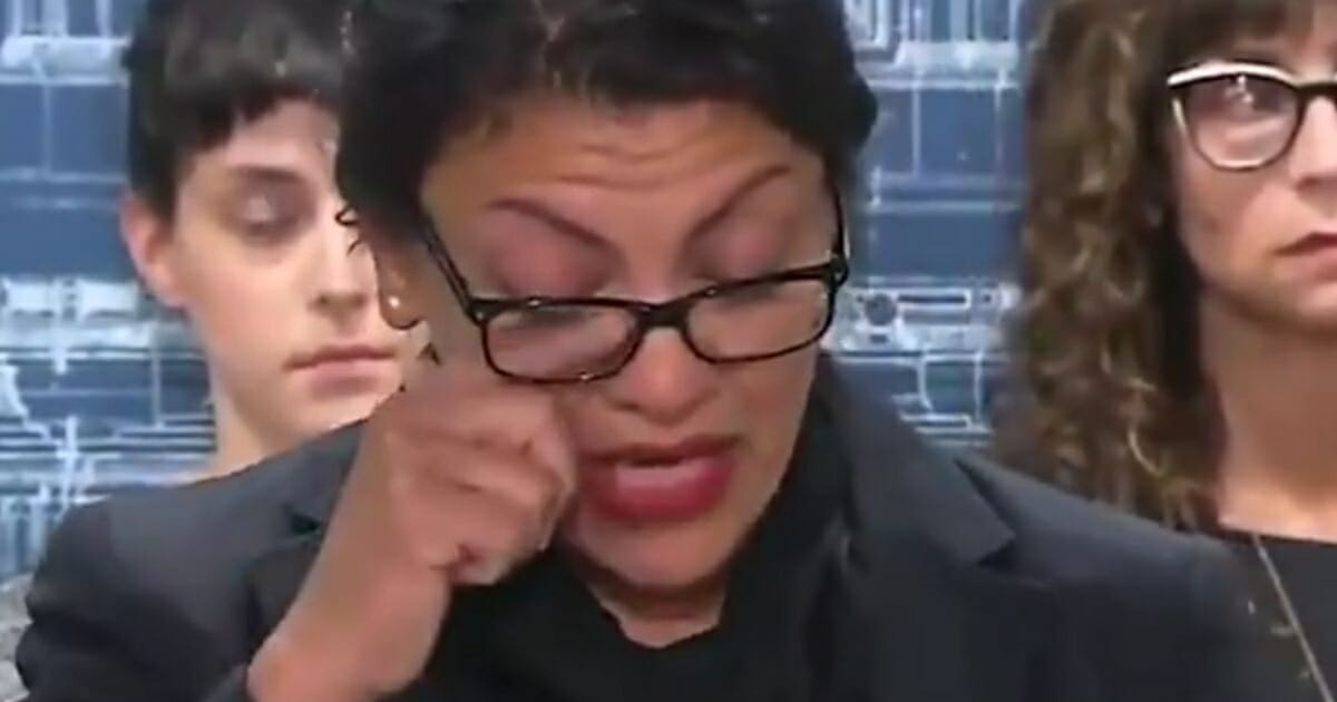 Rep. Rashida Tlaib wipes away tears during a news conference Monday.